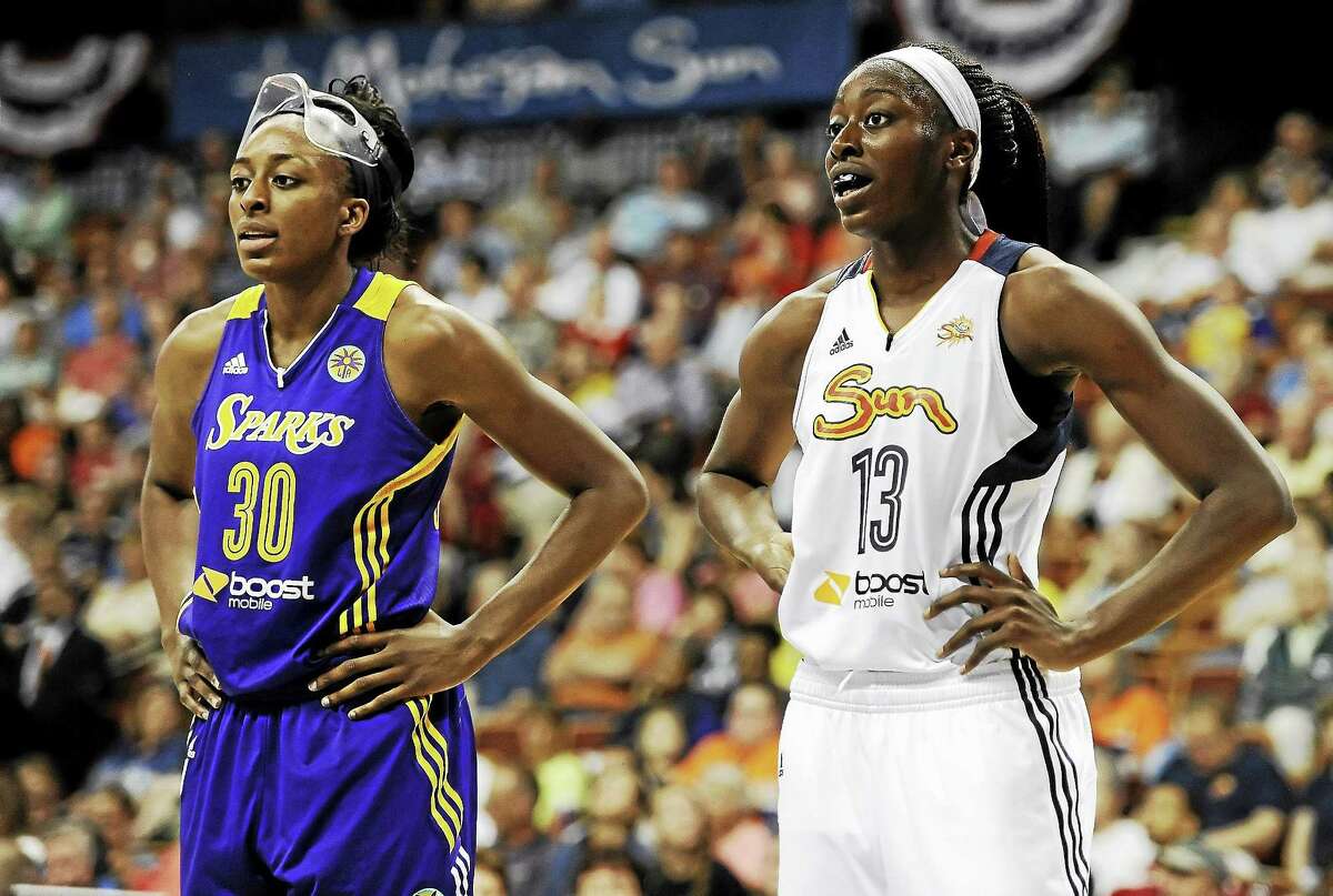 Los Angeles Sparksí Nneka Ogwumike, left, stands with her sister Chiney Ogwumike of the Connecticut Sun, during the first half of a July 13, 2014 game when the two No. 1 picks in the WNBA squared off for the first time as pros. Chiney Ogwmike returned to Sun training camp on Monday.