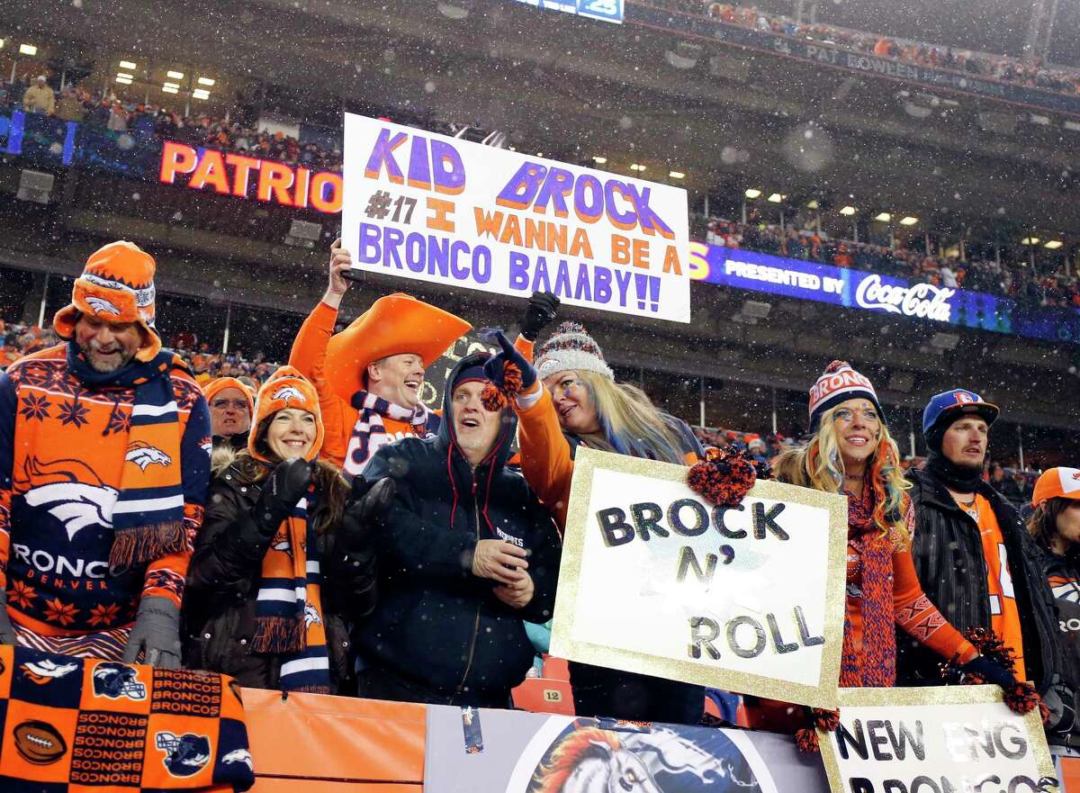 Denver Broncos fans hold signs in support of quarterback Brock Osweiler during a recent game. The Register’s Dan Nowak likes the Broncos as one of three home favorites he will be keying on today.