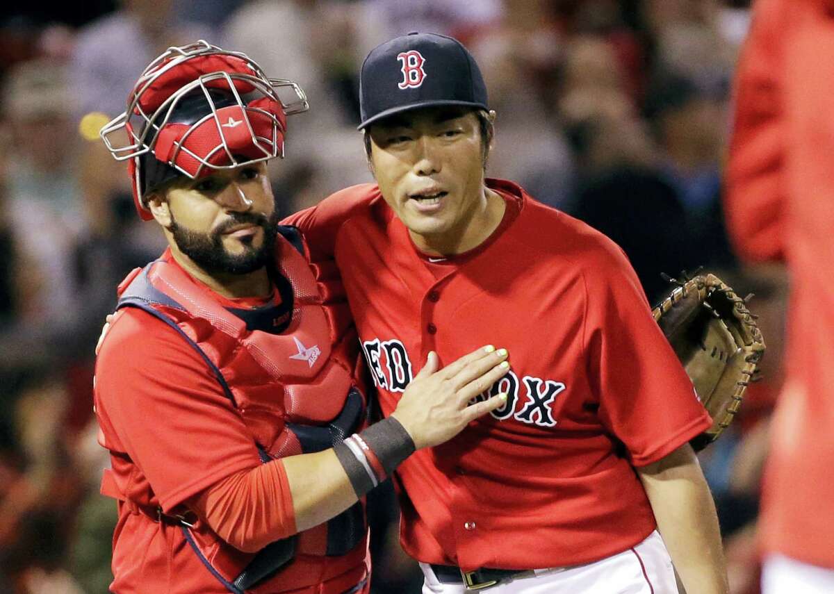 Red Sox catcher Sandy Leon and closer Koji Uehara celebrate after beating the Rays on Friday.