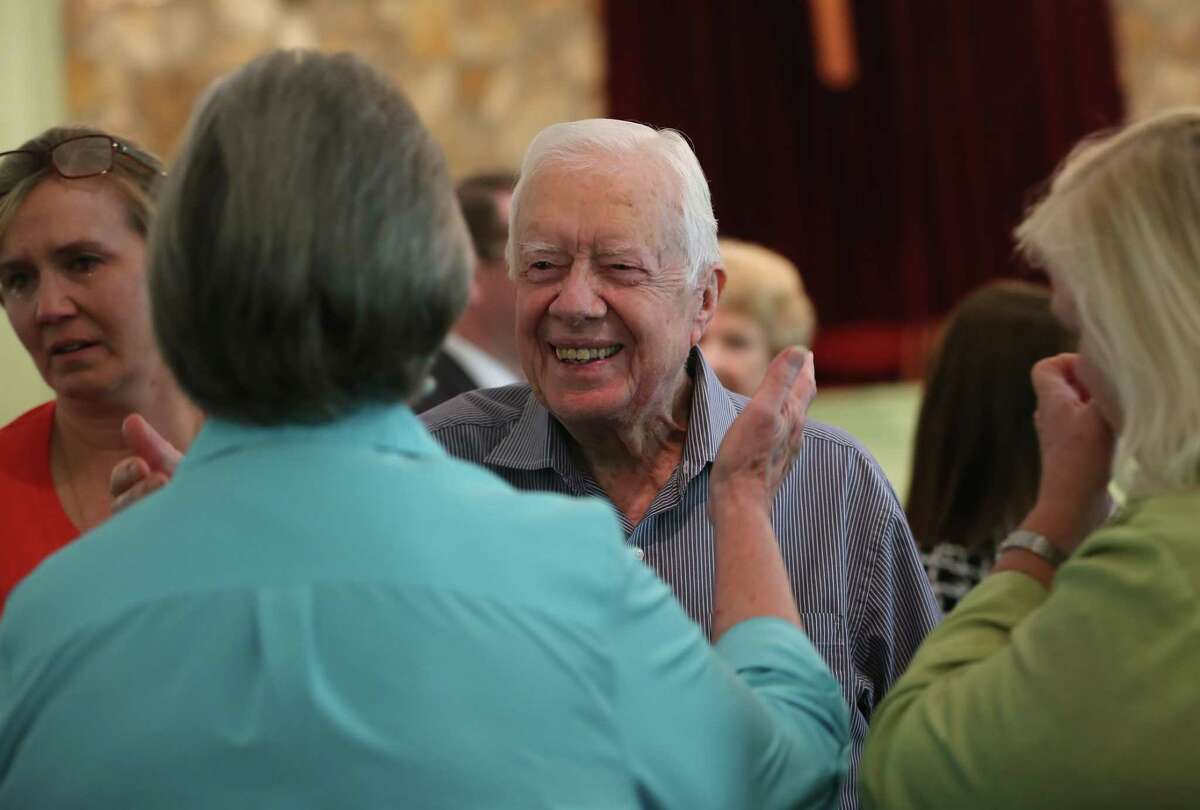 Former President Jimmy Carter reaches to embrace his brother Billy’s widow, Sybil, while greeting family Sunday, Aug. 16, 2015, following a service at Maranatha Baptist Church in Plains, Ga. Carter’s nieces, Mandy Flynn, left, and Jana Carter, are also pictured. Sunday at church was emotional because it was the first time many members had seen Carter since his announcement that he has cancer.