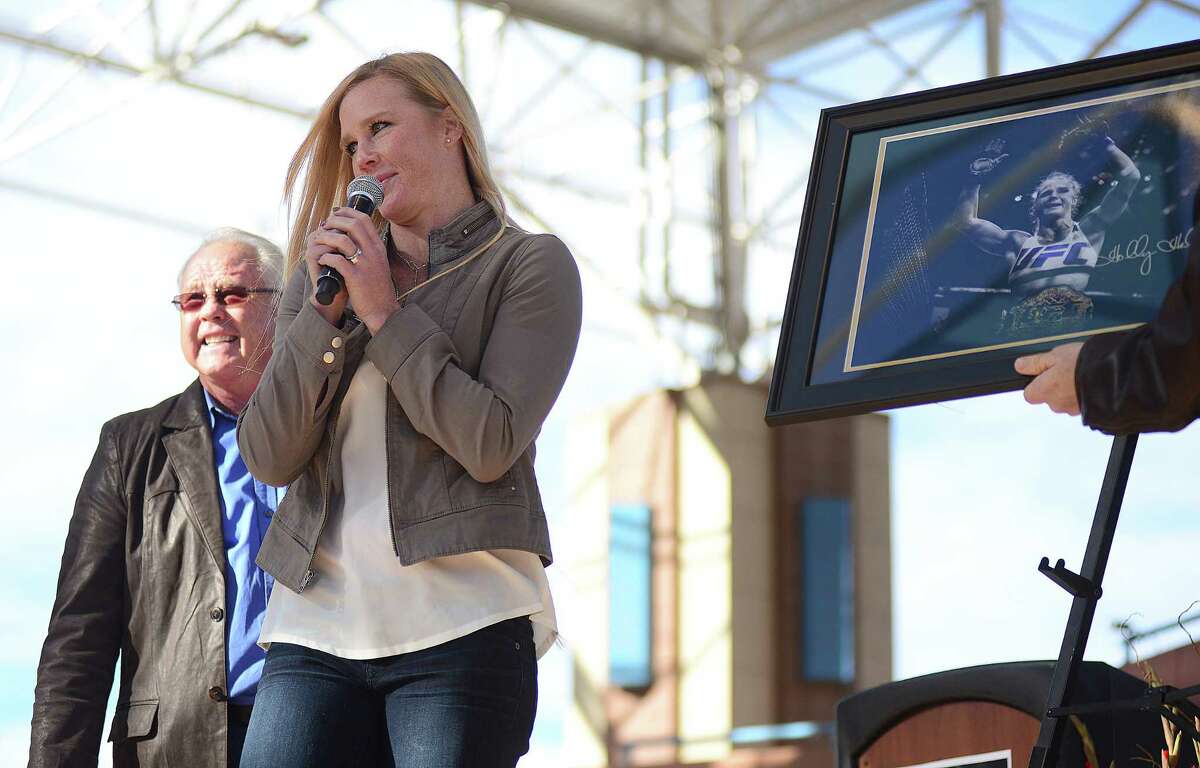 UFC bantamweight champion Holly Holm speaks to a packed Civic Plaza Sunday in Albuquerque, N.M., following a parade in her honor. Holm captured the belt from the previously undefeated Ronda Rousey on Nov. 14.