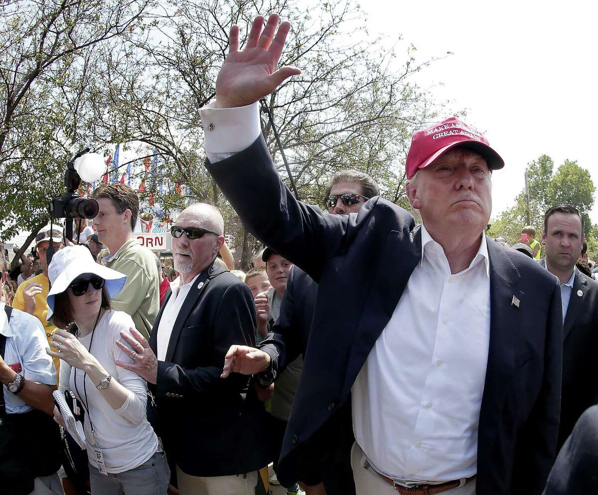 In this Aug. 15, 2015 photo, Republican presidential candidate Donald Trump waves to the crowd at the Iowa State Fair in Des Moines.