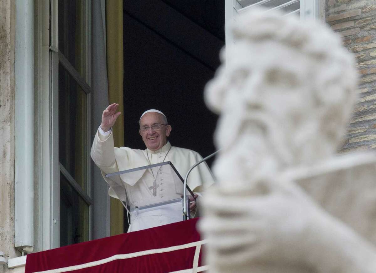 Pope Francis delivers his blessing from the window of his studio overlooking St. Peter’s Square during the Angelus noon prayer at the Vatican on Sunday, Aug. 16, 2015.