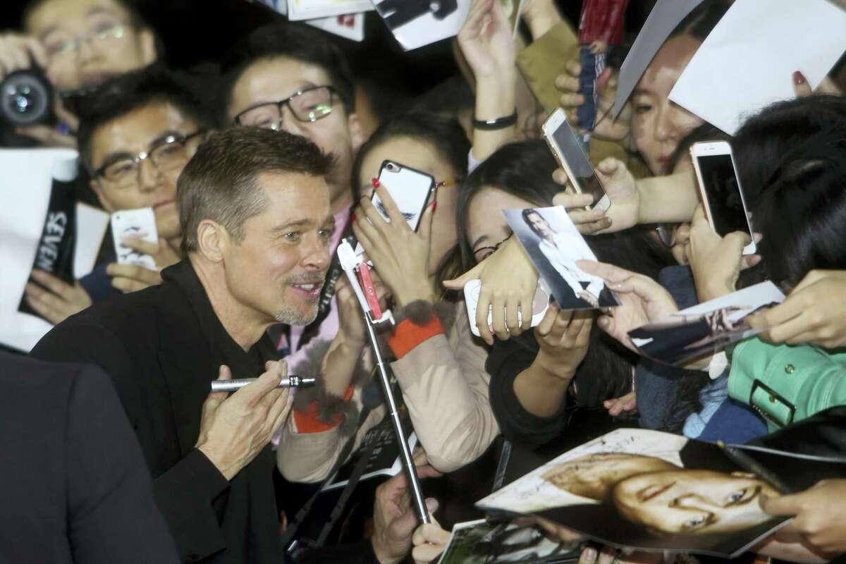 Actor Brad Pitt poses for photos with Chinese fans as he arrives at a premiere of director Robert Zemeckis’ new film ‘Allied’ in Shanghai, China on Nov. 14, 2016. Brad Pitt made his first promotional appearance for a movie in China since reportedly being banned over a film about Tibet almost 20 years ago.