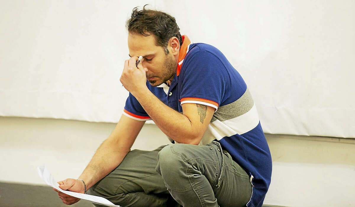 Iraqi refugee Ali Al Saadi working on his lines for “Voices From the Long War.”