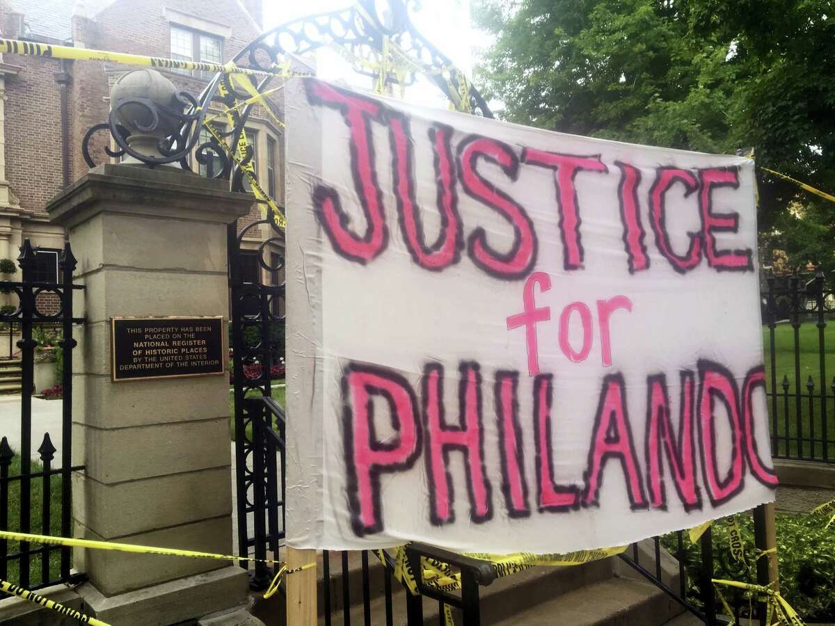 A sign is hung outside the Minnesota Governor’s Residence as about 200 people gathered in St. Paul, Thursday, July 7, 2016, protesting the fatal shooting of a man by a suburban police officer. Philando Castile was shot in a car Wednesday night in the largely middle-class St. Paul suburb of Falcon Heights. Police have said the incident began when an officer initiated a traffic stop in suburban Falcon Heights but have not further explained what led to the shooting.