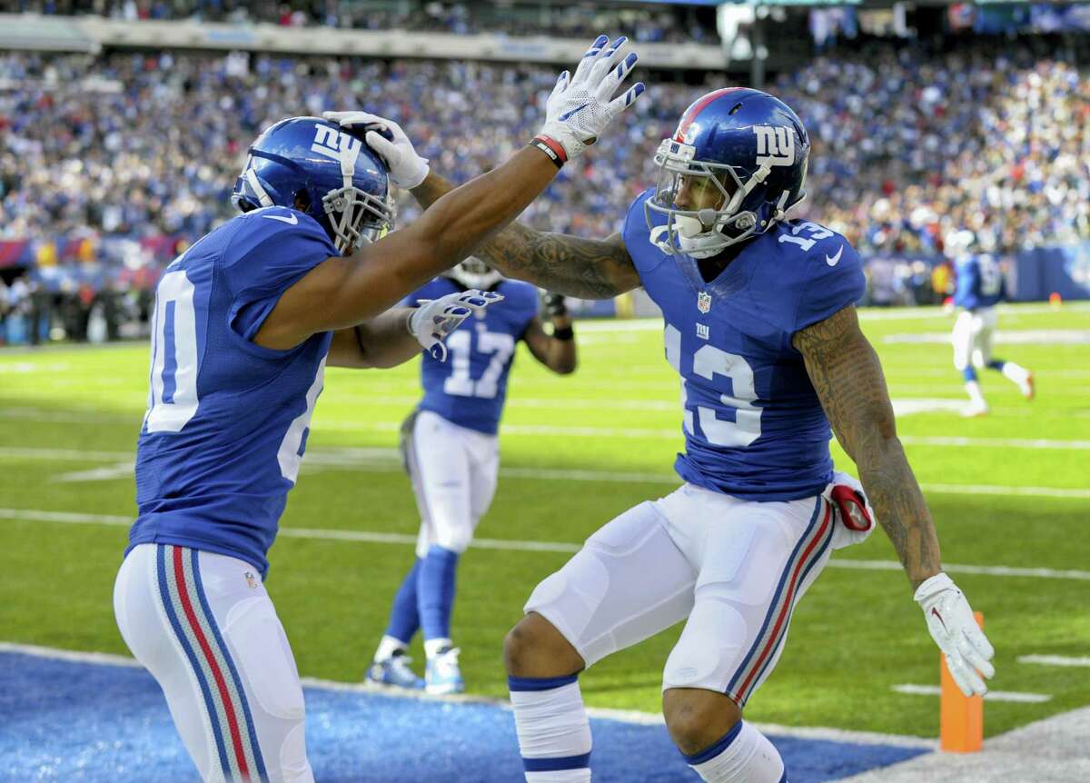 New York Giants wide receiver Odell Beckham (13) celebrates with wide receiver Victor Cruz (80) after scoring a touchdown against the Philadelphia Eagles during the first quarter of an NFL football game, Sunday, Nov. 6, 2016, in East Rutherford, N.J. (AP Photo/Bill Kostroun)