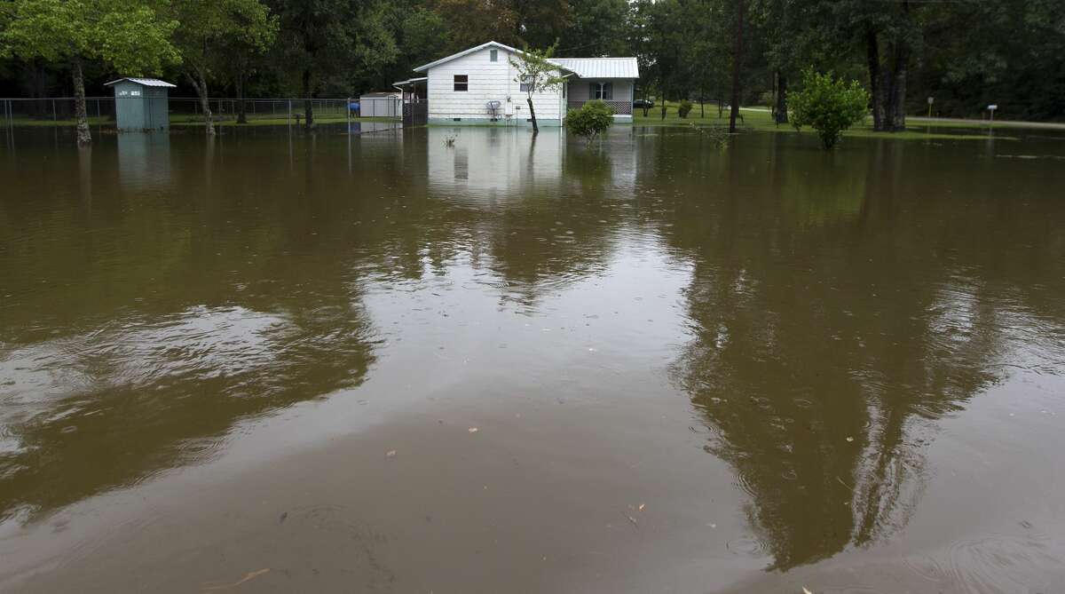 Flood water near is seen around a house on East Old Highway 105 East and South Duck Creek Road in East Montgomery County, Saturday, Aug. 26, 2017.