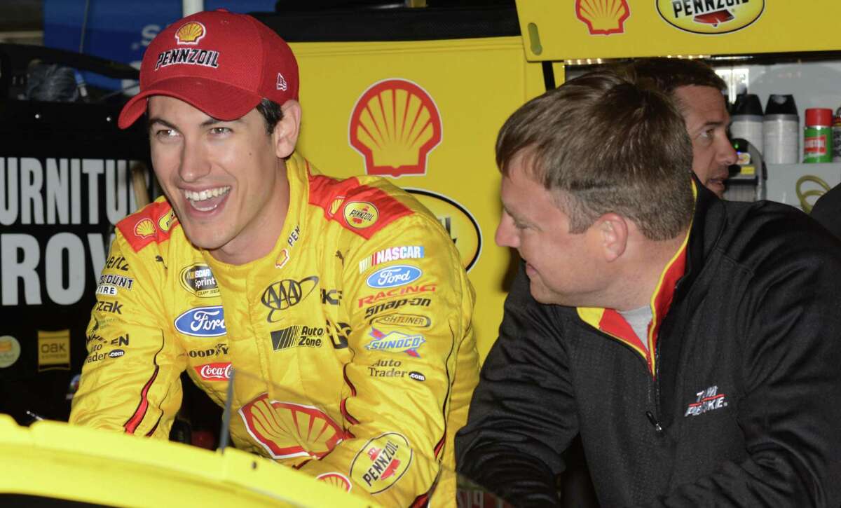 NASCAR driver Joey Logano, left, laughs while chatting with his crew in the garage during a practice session for the Texas Motor Speedway on Friday in Fort Worth, Texas.