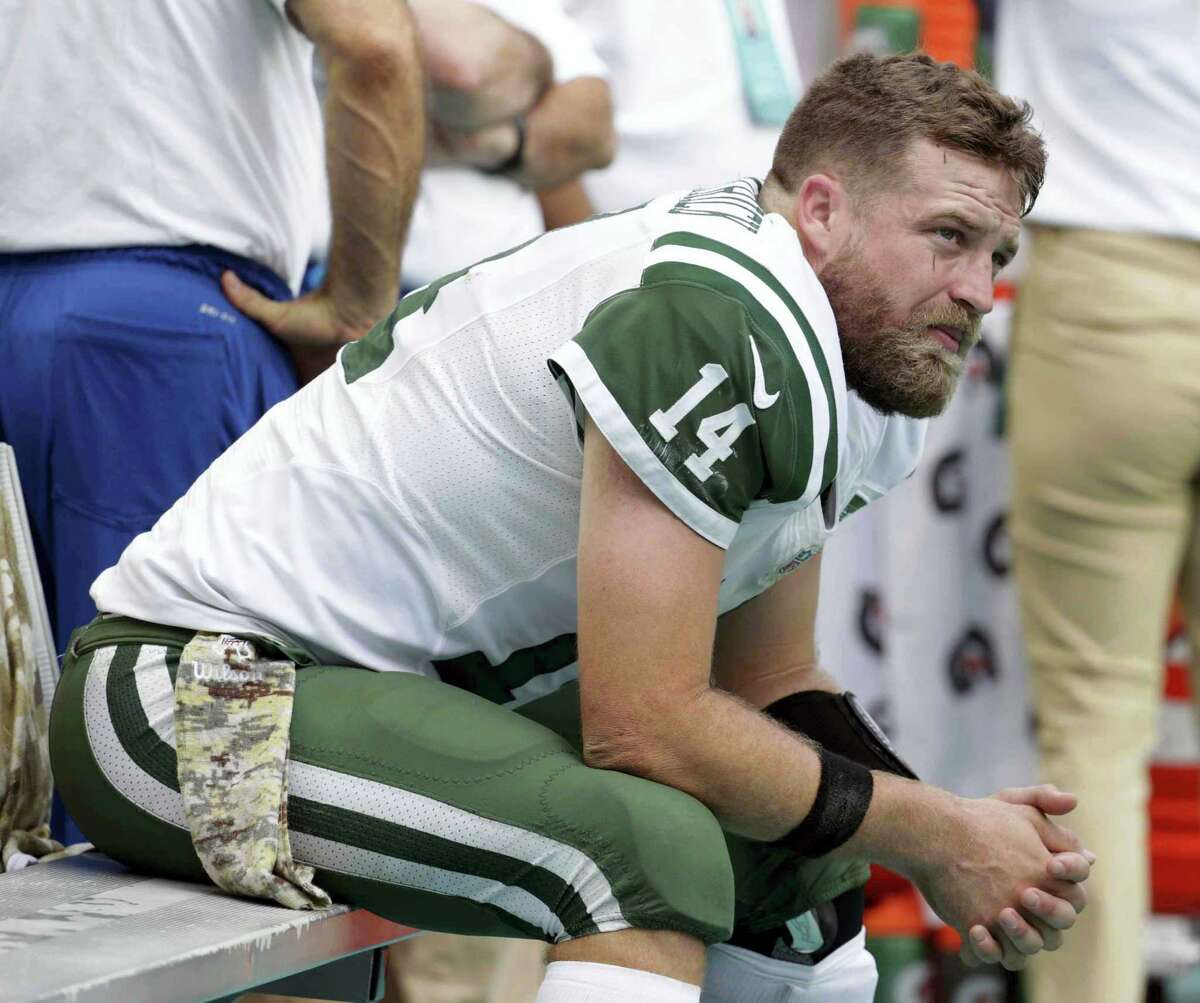New York Jets quarterback Ryan Fitzpatrick (14) sits on the sidelines during the second half against the Miami Dolphins. He will be a game-time decision today.