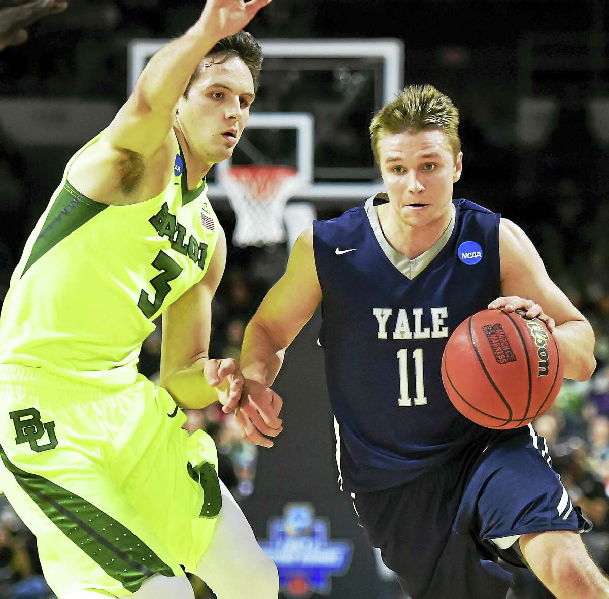 Yale's Makai Mason drives to the hoop as Baylor's Alex Copeland defends in the 79-75 victory for the Bulldogs in the first round of the 2016 NCAA Men's Basketball Tournament at the Dunkin' Donuts Center in Providence, RI. (Catherine Avalone/New Haven Register)