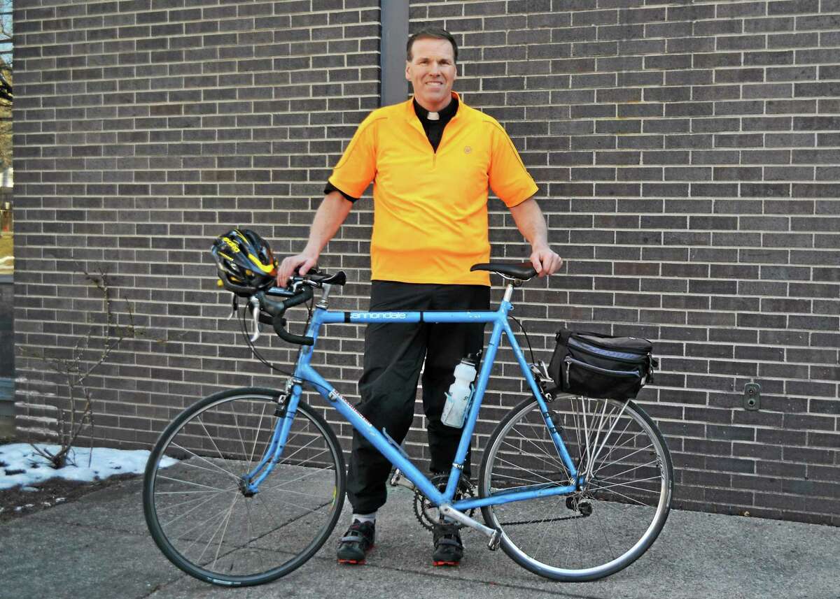 Father Jim Sullivan will bike 350 miles to raise money for St. Peter/St. Francis School in Torrington.