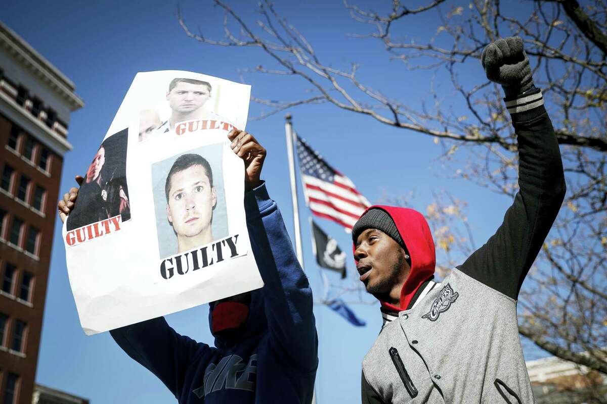 Protestors chant outside the Hamilton County Courthouse after a mistrial is declared due to a hung jury in the murder trial against Ray Tensing, Saturday, Nov. 12, 2016, in Cincinnati. Tensing, a white former University of Cincinnati police officer, is charged with murder in the shooting of Sam DuBose, an unarmed black motorist, while on duty during a routine traffic stop on July 19, 2015.