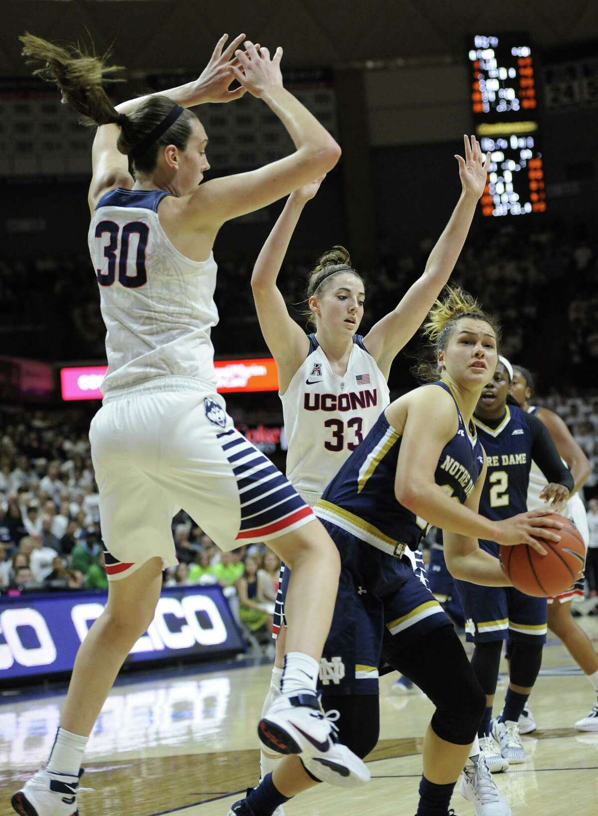 UConn’s Breanna Stewart, left, and Katie Lou Samuelson, center, guard Notre Dame’s Kathryn Westbeld during Saturday’s game.