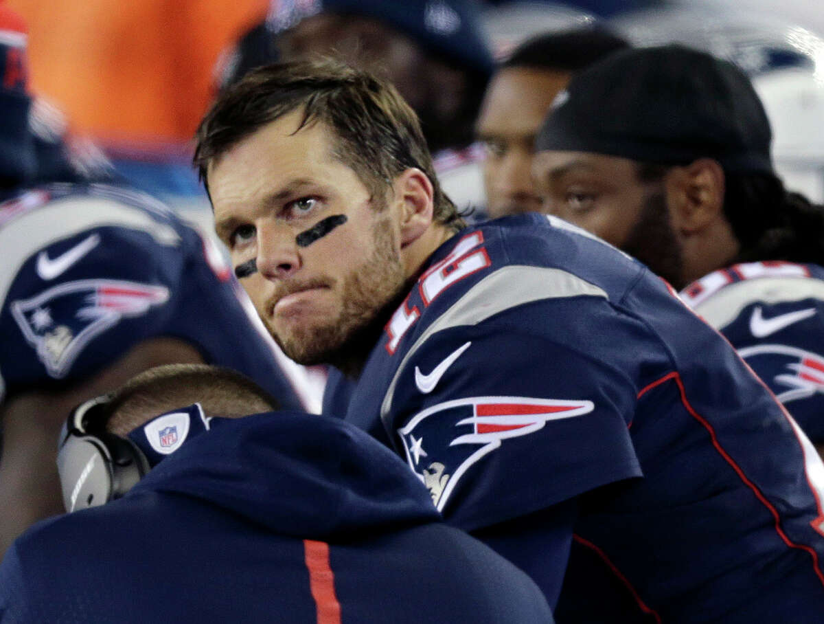 Patriots quarterback Tom Brady watches from the sideline during the second half of Sunday’s loss to the Eagles.