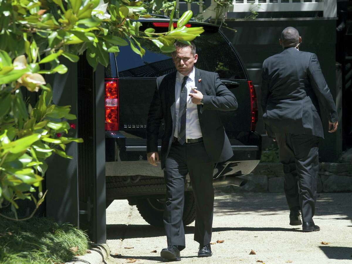Secret Service stand guard around a Secret Service vehicle after it arrived at the home of Democratic presidential candidate Hillary Clinton in Washington, Saturday, July 2, 2016. The Clinton campaign says the FBI interviewed Clinton on Saturday morning in Washington about her emails while she was secretary of state.