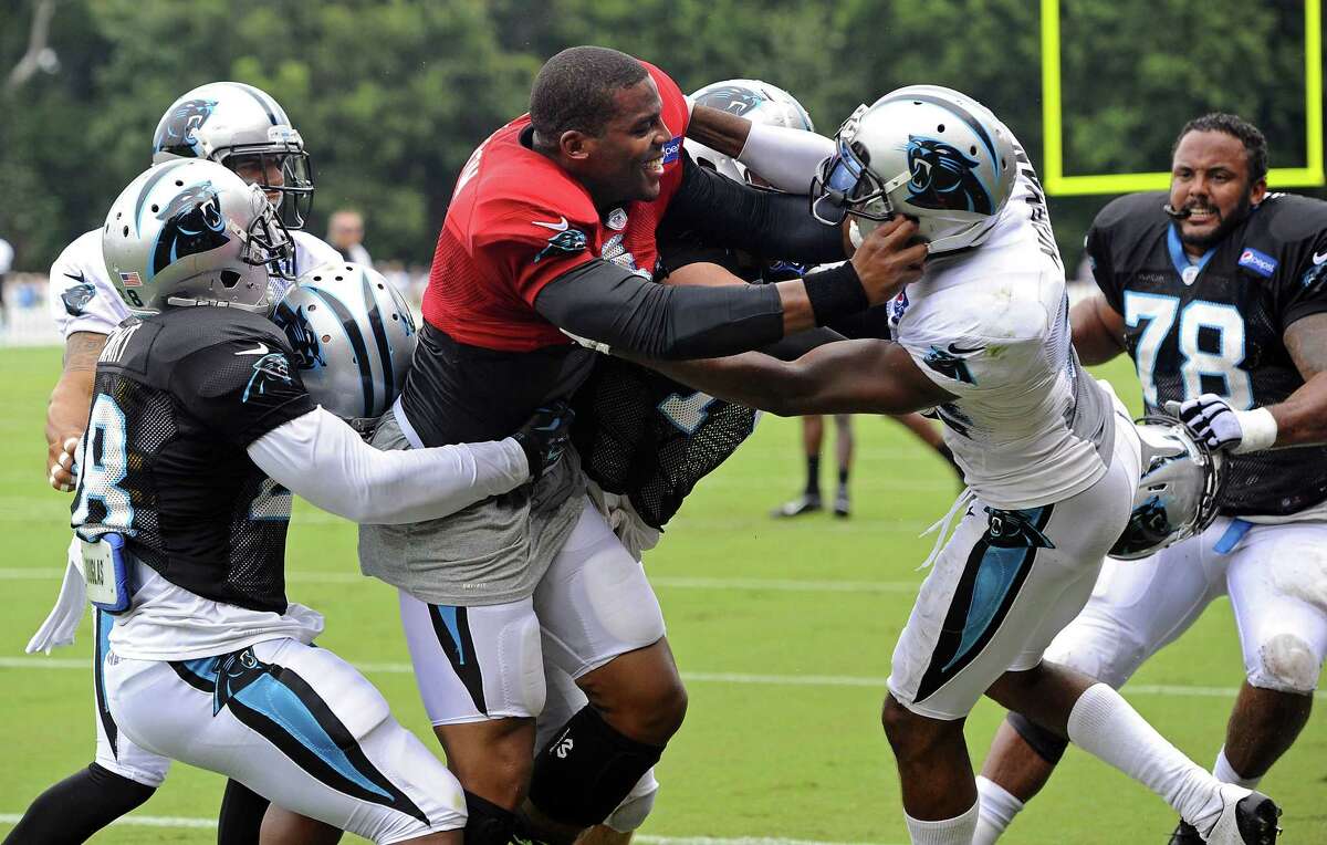 Carolina Panthers quarterback Cam Newton (1), left center, and Josh Norman (24), right center, scuffle at training camp on Monday at Wofford College in Spartanburg, S.C.