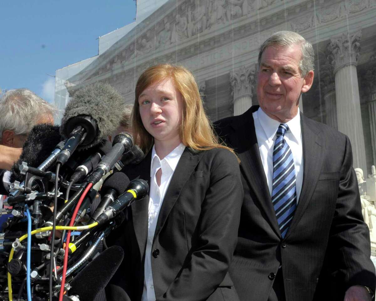 In this Oct. 10, 2012 photo, Abigail Fisher, the Texan involved in the University of Texas affirmative action case, accompanied by her attorney Bert Rein, talks to reporters outside the Supreme Court in Washington.