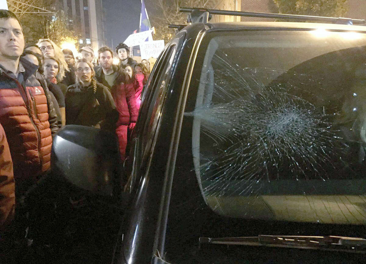 A driver’s windshield was damaged after she drove in the area with protesters demonstrating against Tuesday’s U.S. presidential election results, Thursday, Nov. 10, 2016, in Portland, Ore. President-elect Donald Trump fired back on social media after demonstrators in both red and blue states hit the streets for another round of protests, showing outrage over the Republican’s unexpected win.