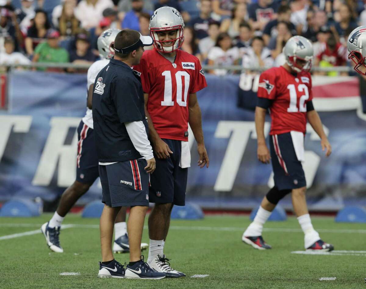 New England Patriots quarterback Jimmy Garoppolo (10) talks with offensive coordinator Josh McDaniels during training camp last week in Foxborough, Mass.