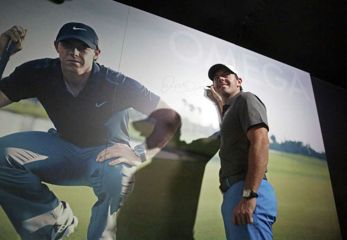Rory McIlroy signs a wall at the Omega exhibit before a practice round for the PGA Championship Wednesday at Whistling Straits in Haven, Wis.