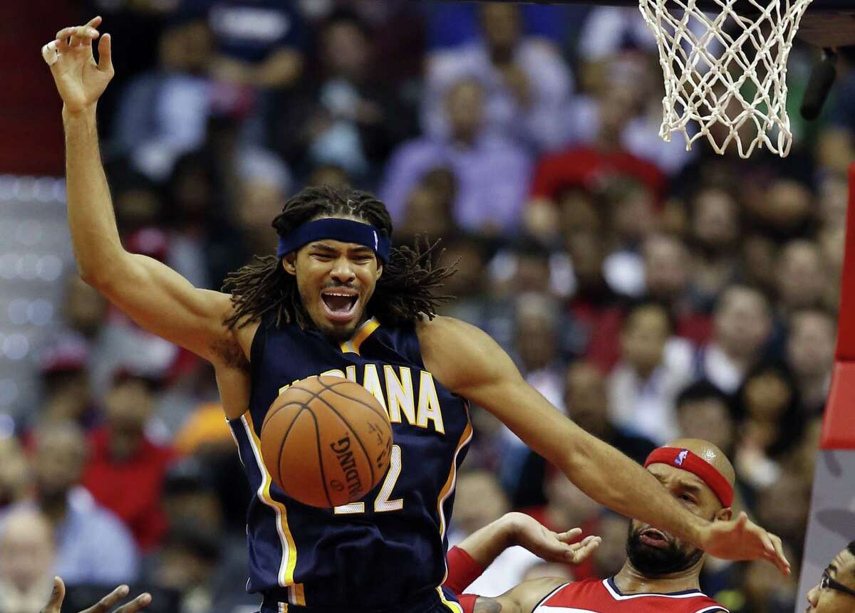 In this Nov. 5, 2014 photo, Indiana Pacers forward Chris Copeland (22) loses control of the ball as he is guarded by Washington Wizards forward Drew Gooden (90) and forward Otto Porter Jr. (22) during the first half of an NBA basketball game in Washington.