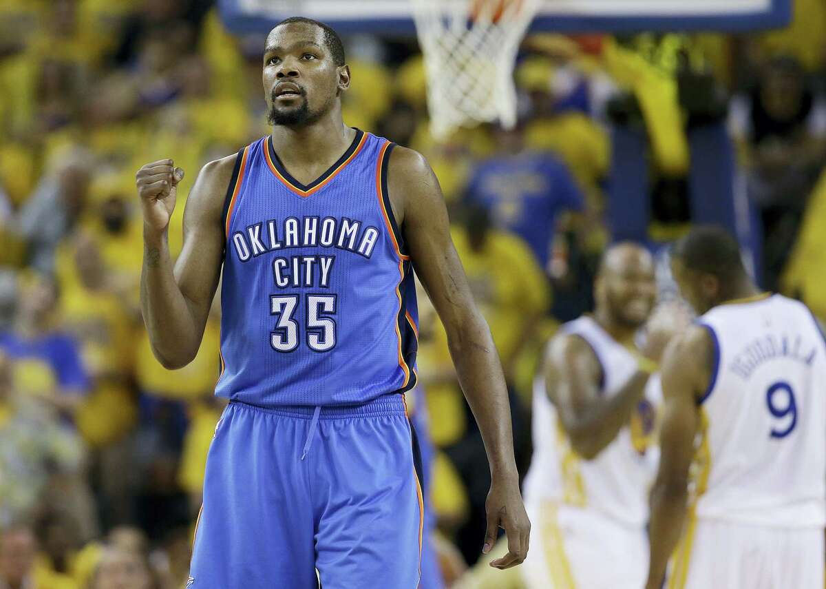 FILE - In this May 30 file photo, Oklahoma City Thunder forward Kevin Durant reacts during the second half of Game 7 of the NBA basketball Western Conference finals against the Golden State Warriors. Durant announced Monday that he will sign with the Golden State Warriors.