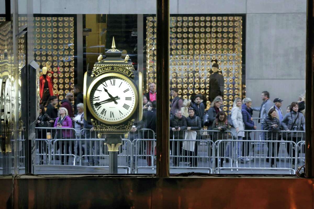 People stop to look at the front of Trump Tower on Fifth Avenue in New York Friday.