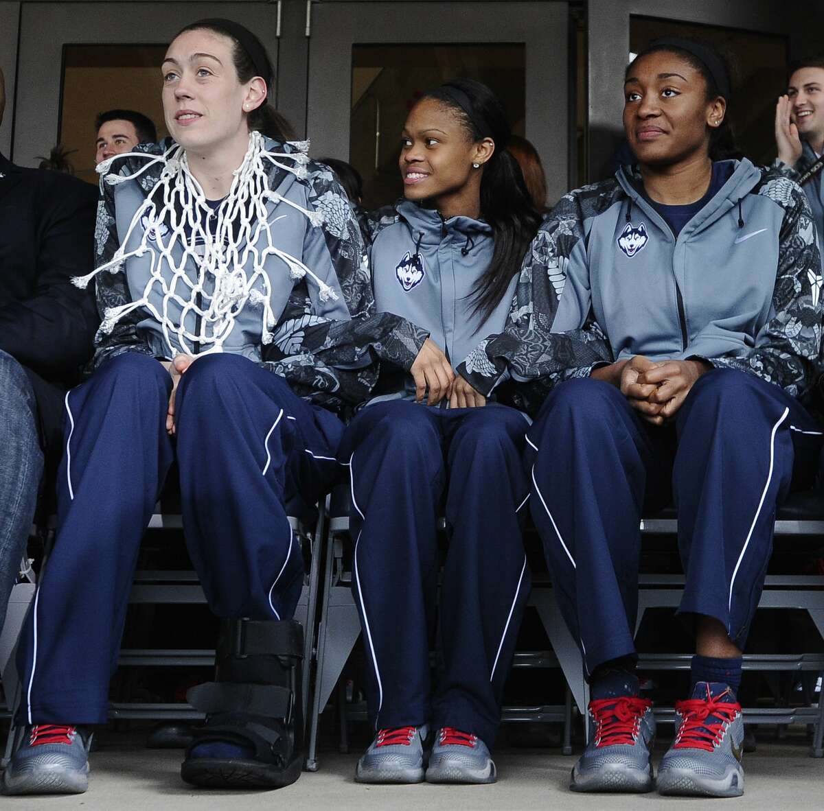 UCOnn’s Breanna Stewart, left, Moriah Jefferson, center, and Morgan Tuck sit during a rally on campus to celebrate their team’s 10th national title and third in a row on Wednesday in Storrs.