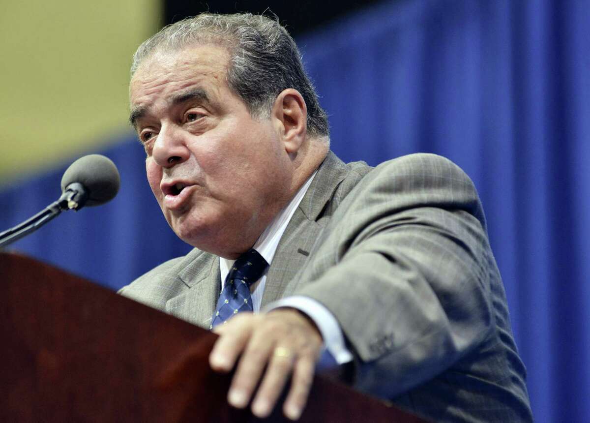 In this Oct. 2, 2013, file photo, Supreme Court Justice Antonin Scalia speaks at Tufts University in Medford, Mass.