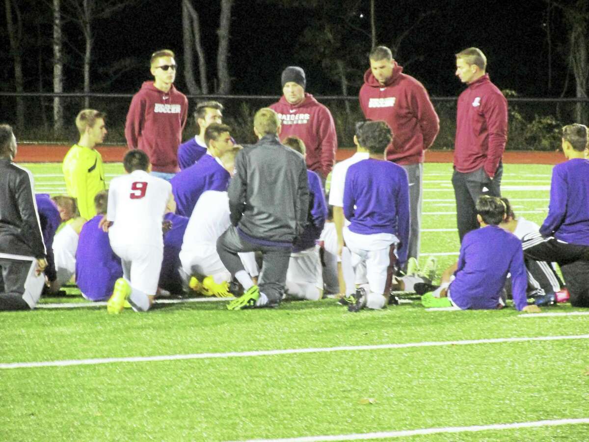 Photo by Peter Wallace Torrington Coach Mike Fritch (second from right) talks to his team after a boys soccer Class L second-round loss to Wethersfield Thursday night at the Robert H. Frost Sports Complex.