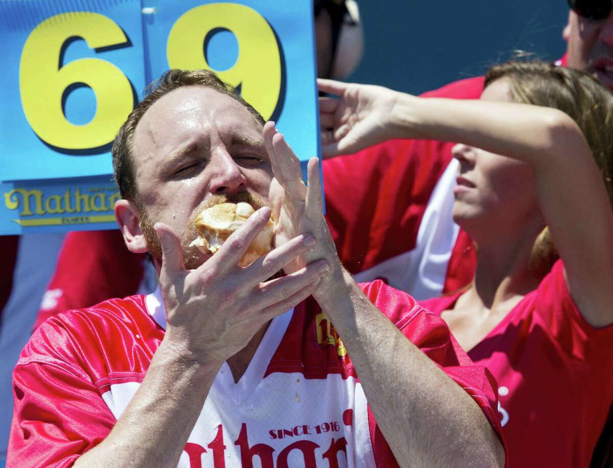 Joey Chestnut competes in Nathan's Famous Fourth of July International Hot Dog Eating Contest men's competition, Monday, July 4, 2016, in New York. Chestnut came in first eating 70 hot dogs and buns in 10 minutes. (AP Photo/Mary Altaffer)