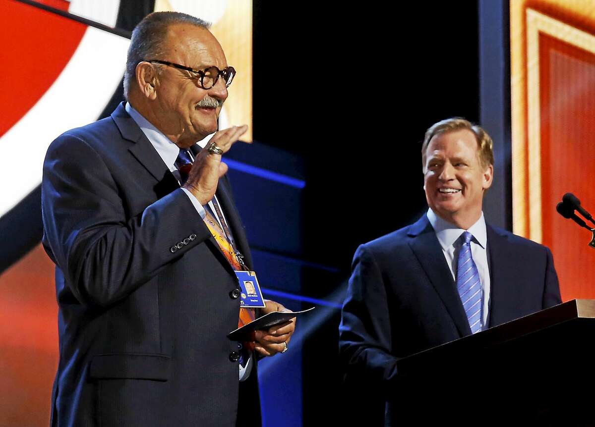 NFL Hall of Famer Dick Butkus, left, waves as NFL commissioner Roger Goodell introduces him during the 2015 NFL Draft on May 1 in Chicago.