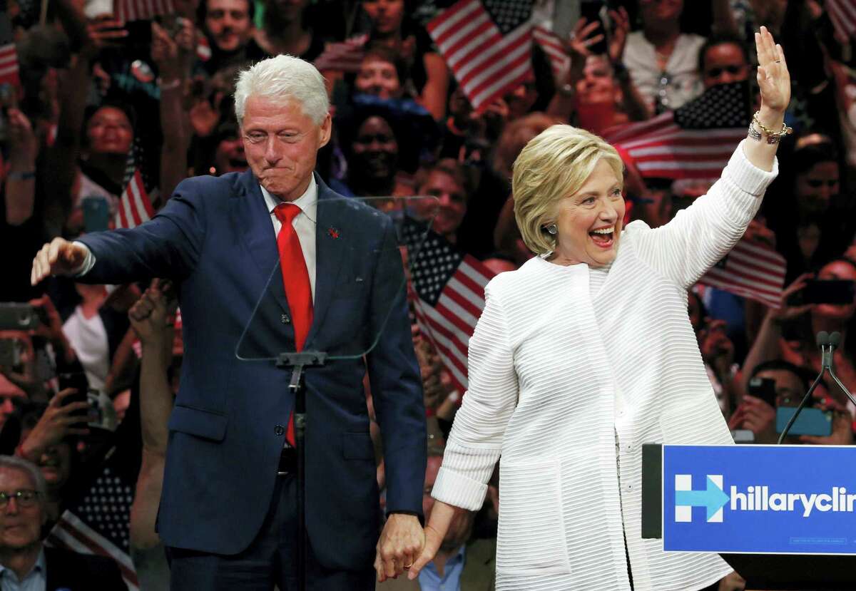 In this June 7 file photo, former President Bill Clinton, left, stands on stage with his wife, Democratic presidential candidate Hillary Clinton, after she spoke during a presidential primary election night rally in New York.