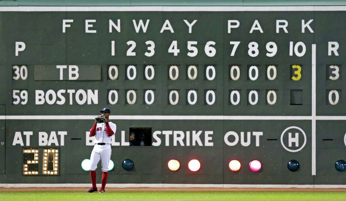 Red Sox left fielder Chris Young stands in front of the scoreboard pitch during the 10th inning on Tuesday.