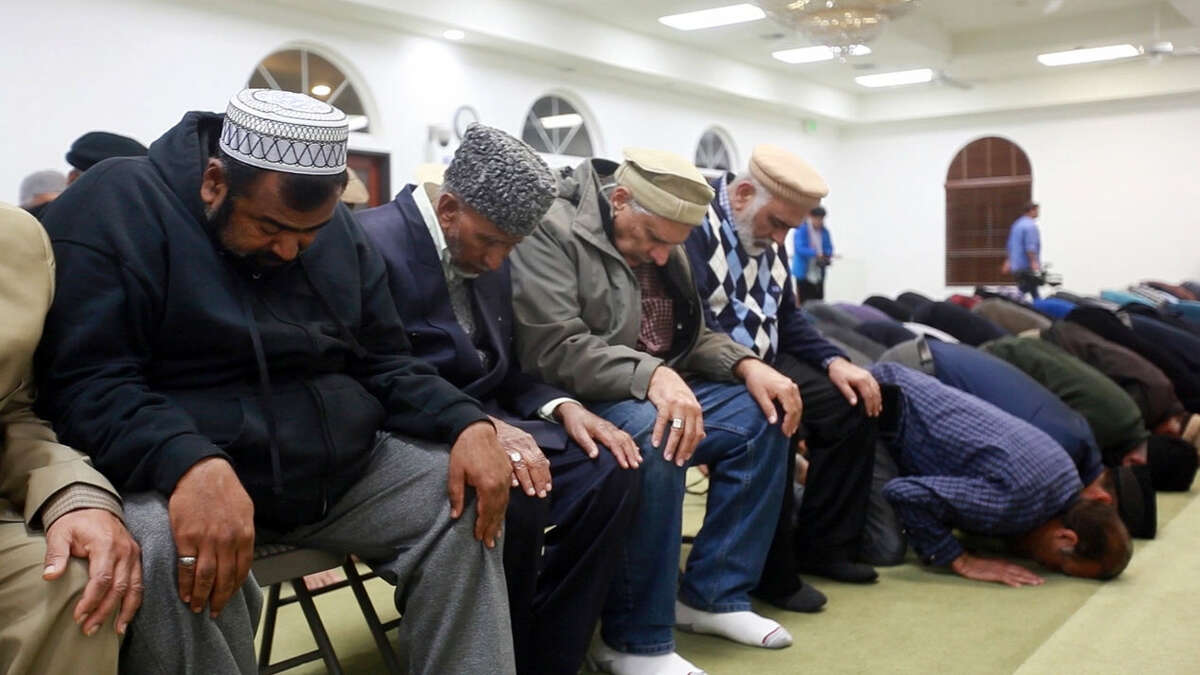 At Baitul Hameed Mosque in Chino, Calif., the Los Angeles chapter of Ahmadiyya Muslim Community hold a vigil for shooting victims Thursday, Dec. 3, 2015. A husband and wife opened fire on a holiday banquet, killing multiple people Wednesday in San Bernardino. Hours later, the couple died in a shootout with police.