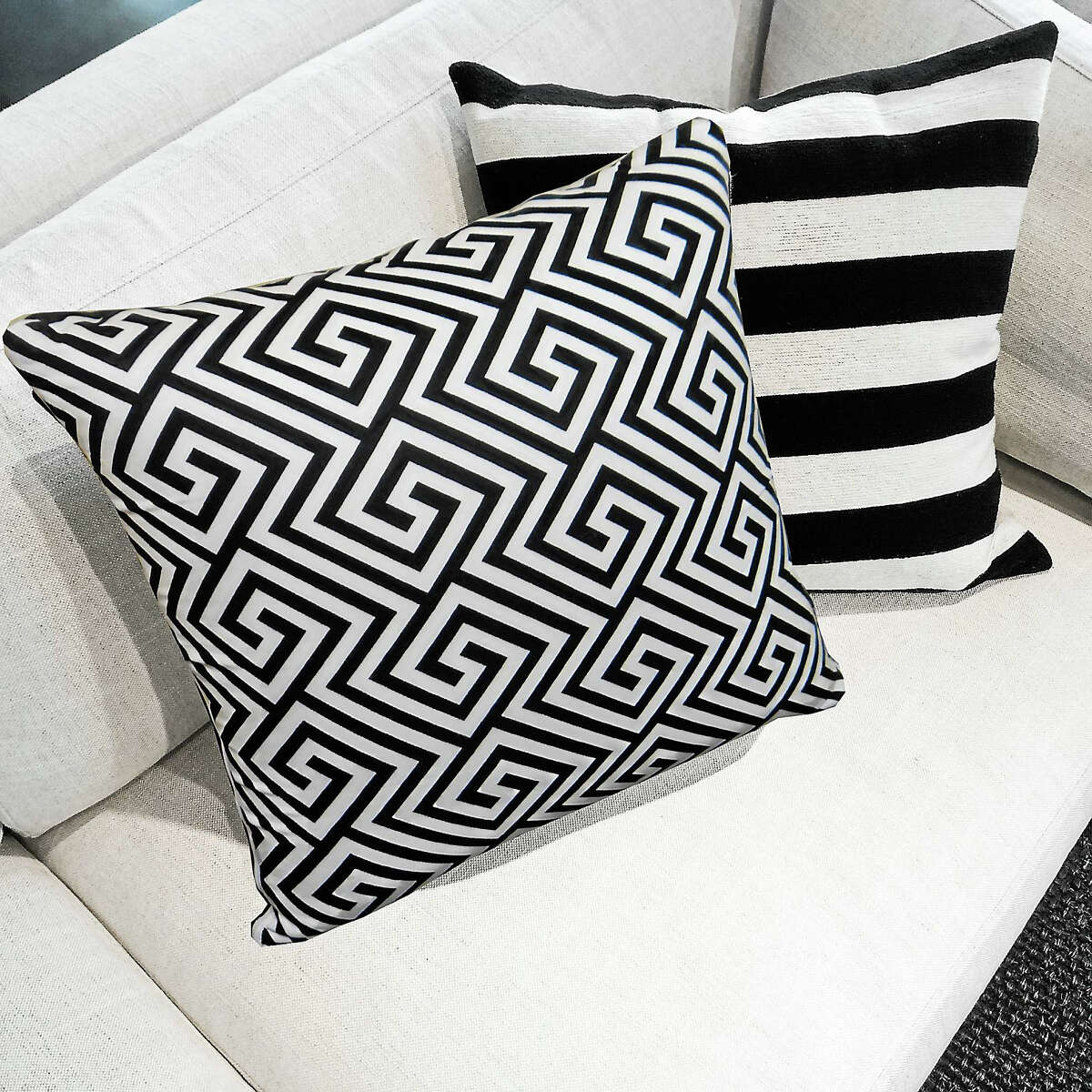 Black and white M Cushions on a sofa