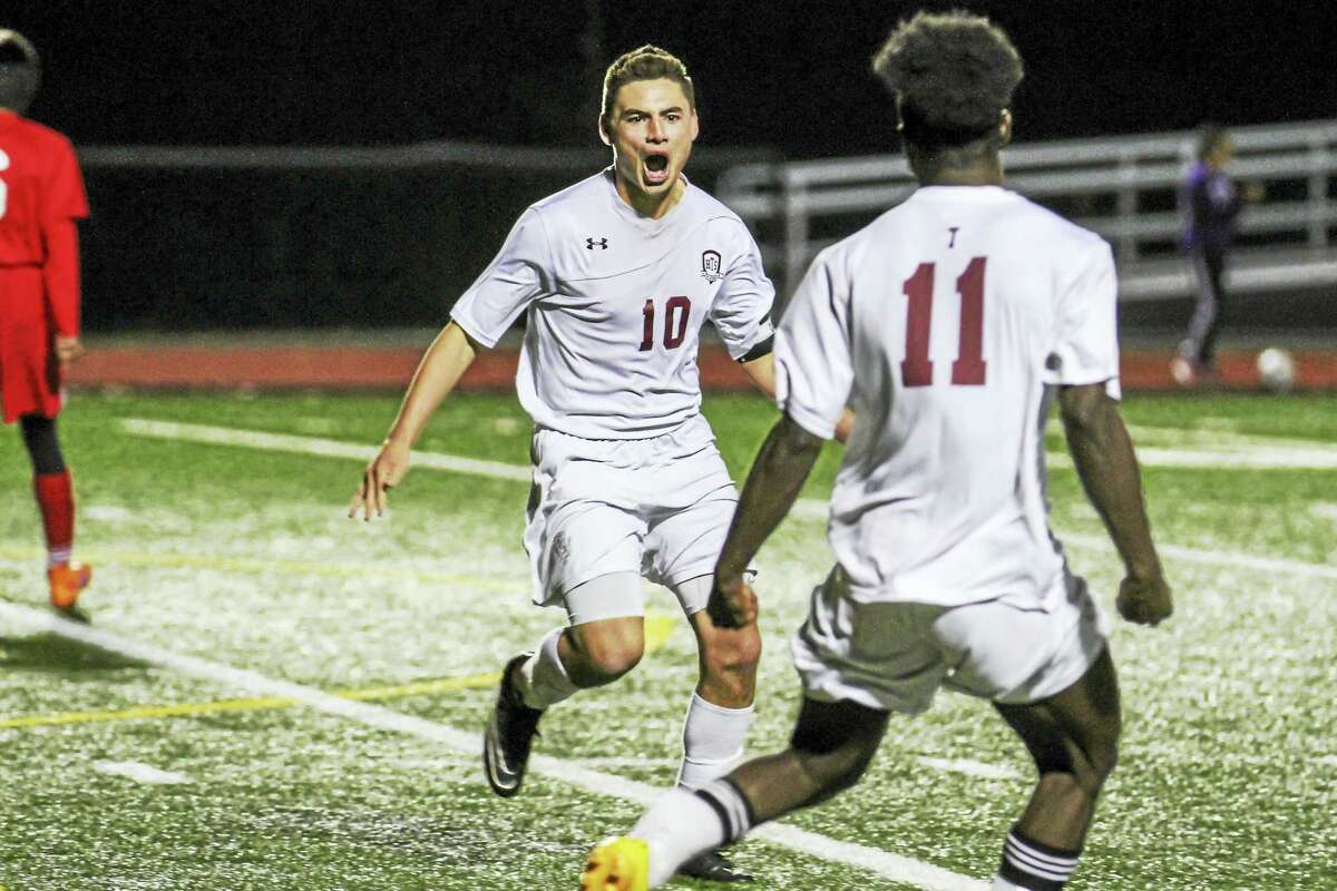 Torrington’s Nick DalleValle (10) and Naseem Thompson celebrate the winning goal in the Red Raiders’ Class L first-round win over Branford Tuesday night at Torrington Robert H. Frost Sports Complex.