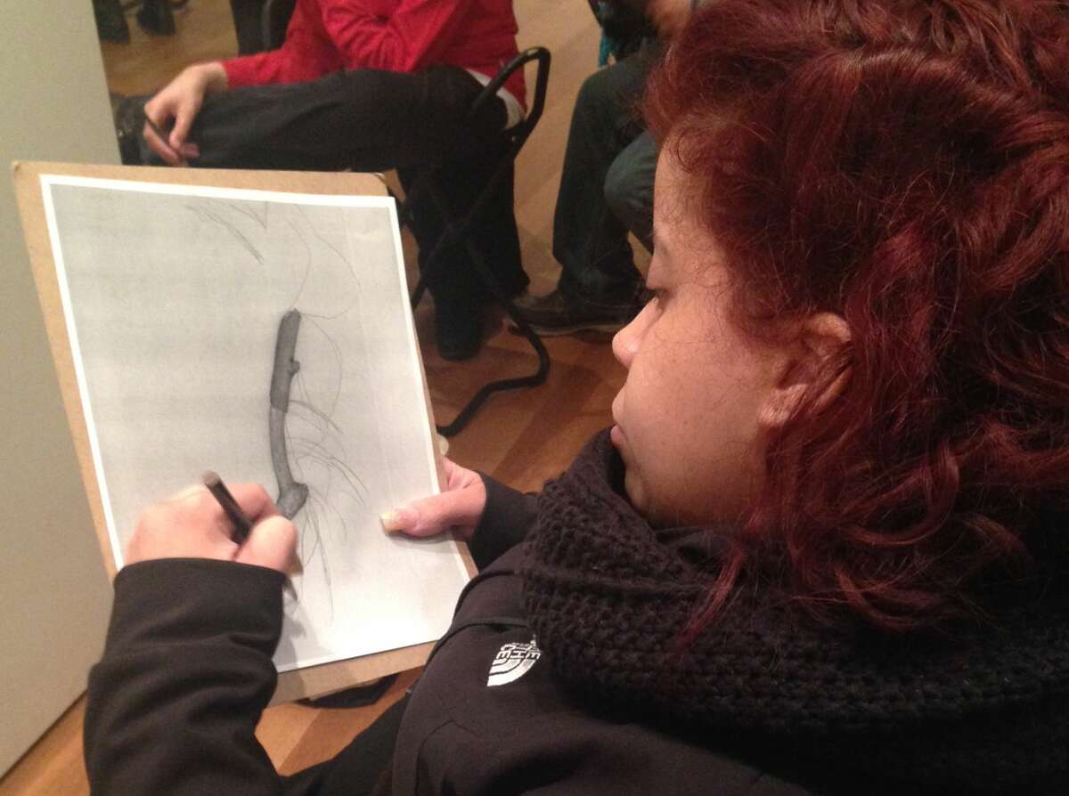 In this March 22, 2015 photo, Luz Cantres works on a drawing at the Museum of Modern Art in New York after viewing a sculpture by French artist Jean Dubuffet. Cantres was participating in “Create Ability,” a program for individuals with learning and developmental disabilities.