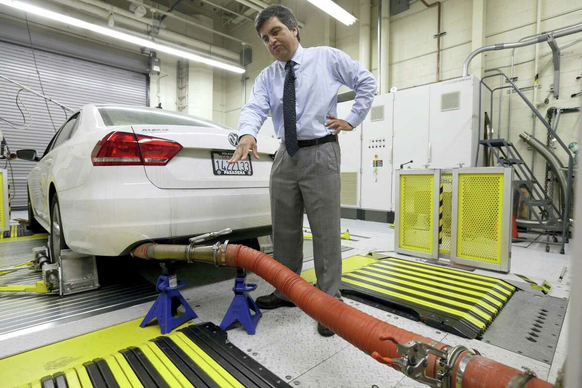In this Sept. 30, 2015 photo, John Swanton, spokesman with the California Air Resources Board, explains how a 2013 Volkswagen Passat with a diesel engine is evaluated at the emissions test lab in El Monte, Calif. Lawyers for thousands of people who own diesel Volkswagens that cheat on emissions tests are asking a judge to order repairs and compensation if the company doesn’t agree to a fix by Thursday, April 21, 2016.