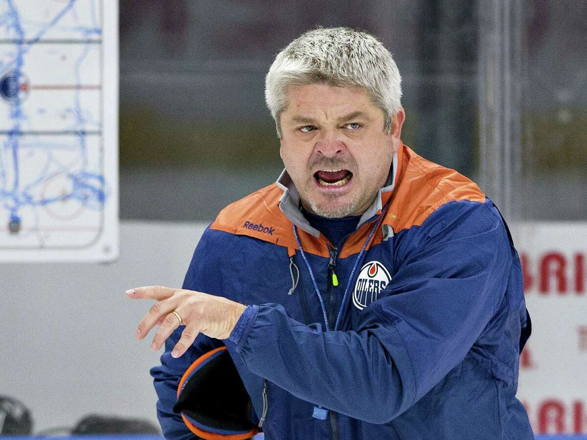 In this Sept. 23, 2016 photo, Edmonton Oilers head coach Todd McLellan runs a drill during NHL hockey training camp in Edmonton, Alberta. A season after Canada was shut out of the NHL playoffs for the first time since 1970, two teams north of the border are off to strong starts. The Montreal Canadiens and the Oilers made major moves in the offseason and they have panned out so far, helping them lead their divisions.