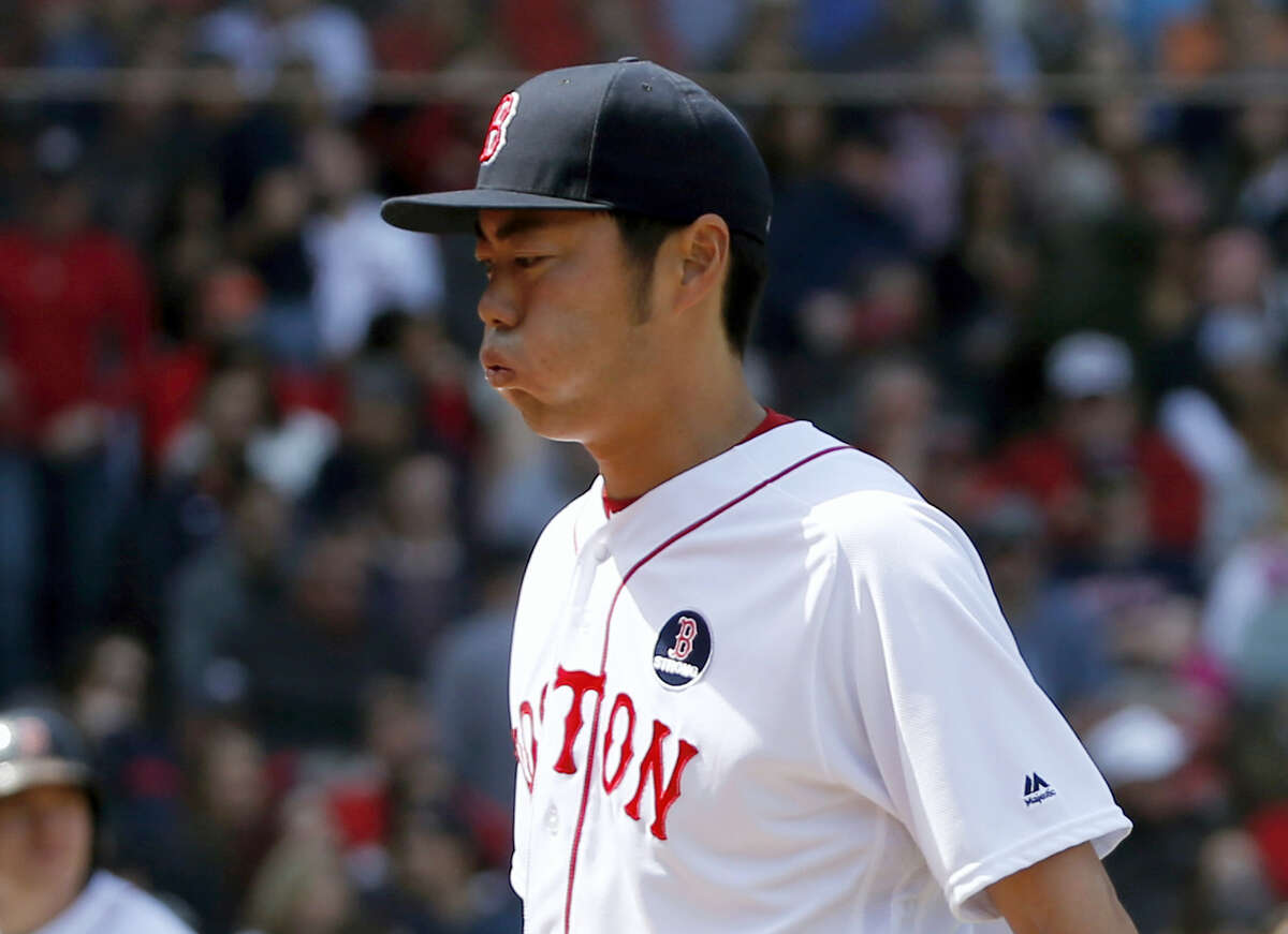 Boston Red Sox relief pitcher Koji Uehara reacts as he leaves the game with the bases loaded during the eighth inning against the Toronto Blue Jays Monday.