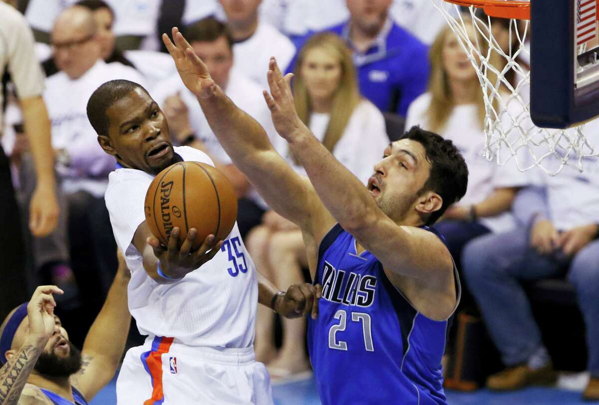 Oklahoma City Thunder forward Kevin Durant (35) goes to the basket as Dallas Mavericks center Zaza Pachulia (27) defends during the first half of Game 2 of a first-round NBA basketball playoff series Monday in Oklahoma City. The Mavs won 85-84 to tie the series.