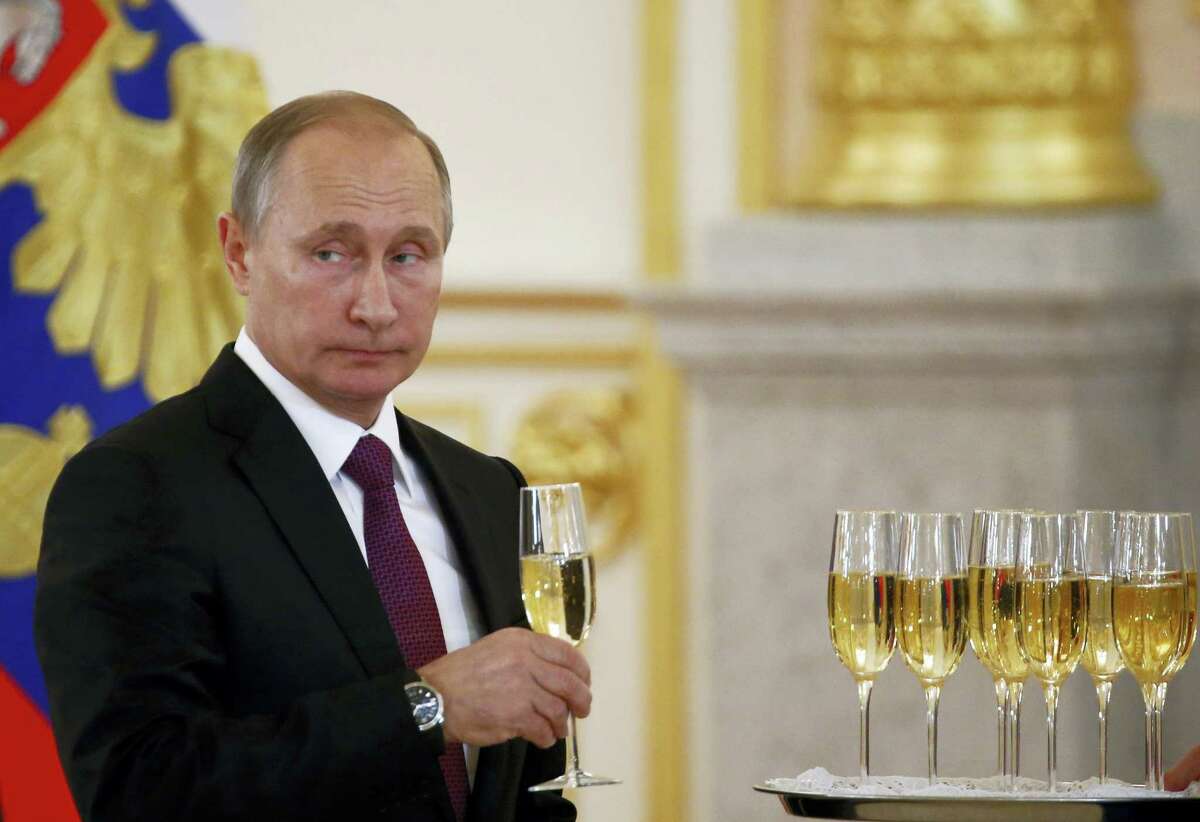 Russian President Vladimir Putin holds a glass during a ceremony of receiving diplomatic credentials from foreign ambassadors in the Kremlin in Moscow, Russia on Wednesday, Nov. 9, 2016. Putin says that Moscow is ready to try to restore good relations with the United States in the wake of the election of Donald Trump.