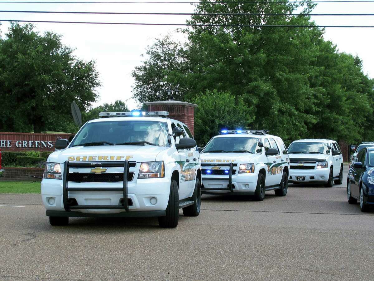 Shelby County Sheriff’s Office vehicles leave a gated neighborhood where four children were found stabbed to death Friday, July 1, 2016, in suburban Memphis, Tenn.