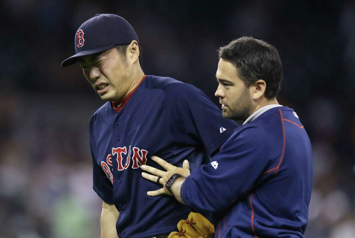 Boston Red Sox closer Koji Uehara is helped off the field after a game against the Tigers on Friday in Detroit.