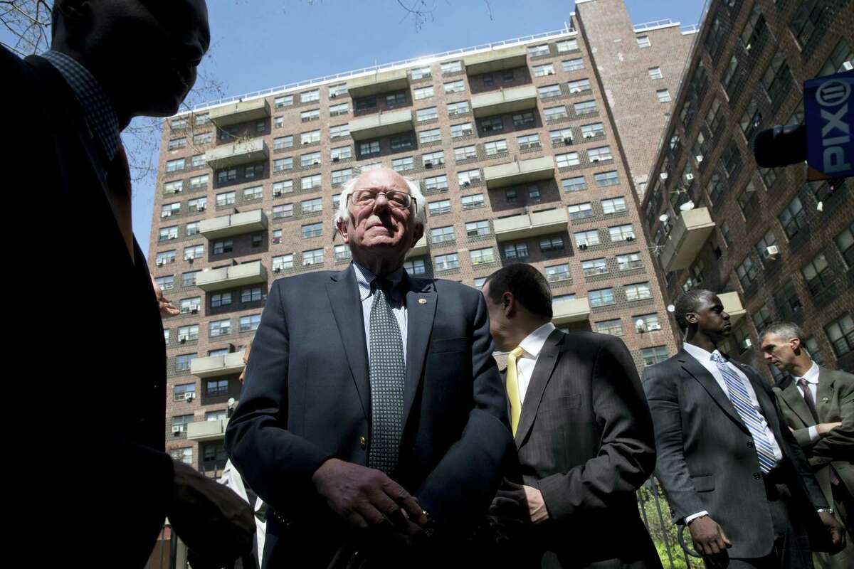 Democratic presidential candidate Sen. Bernie Sanders of Vermont speaks to reporters after touring the Twin Parks housing projects, Monday in the Bronx borough of New York.