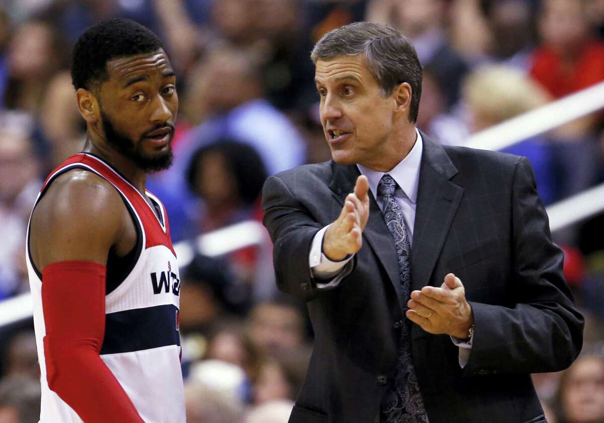 Washington Wizards guard John Wall listens to head coach Randy Wittman.