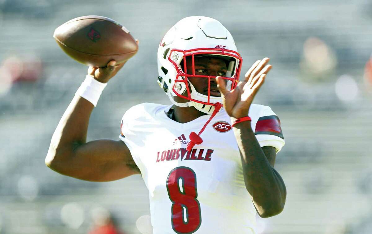 In a Saturday, Oct. 29, 2016 photo, Louisville quarterback Lamar Jackson (8) throws a pass during warmups before an NCAA college football game against Virginia in Charlottesville, Va. Jackson has become one of college football’Äôs most recognizable players the first two months of the season. He enters November as a prohibitive favorite to become Louisville’Äôs first Heisman winner.