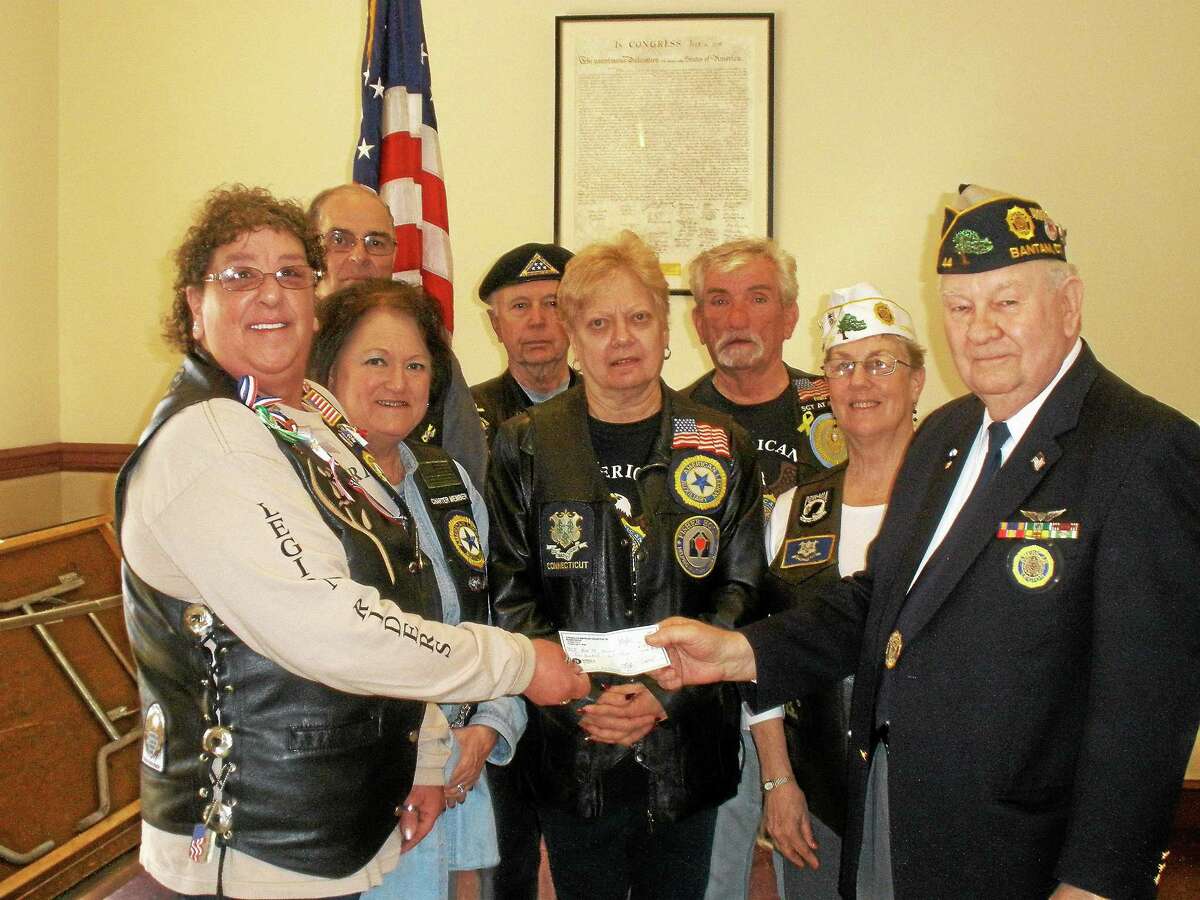 Rose Bristol along with fellow American Legion Riders of Torrington presents John Lilley of Post 44 with a $100 dollar check for continued success.